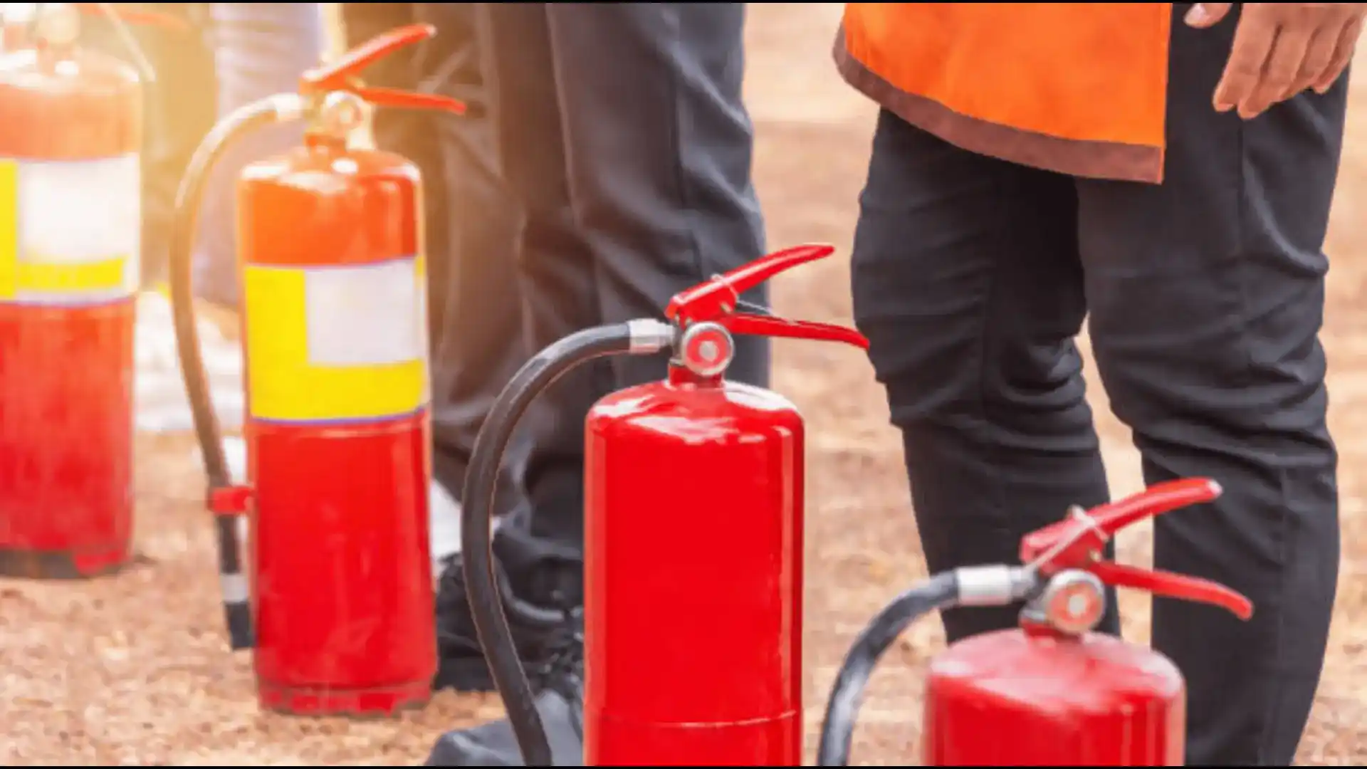 An Image of Workers Pausing with Fire Extinguishers